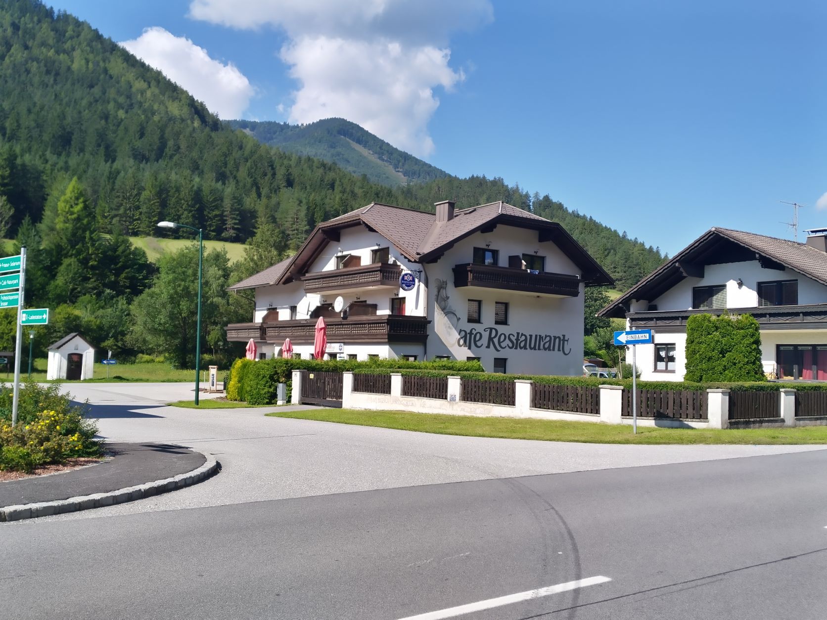 Ein Café-Restaurant in einer ländlichen Gegend mit Bergen im Hintergrund.